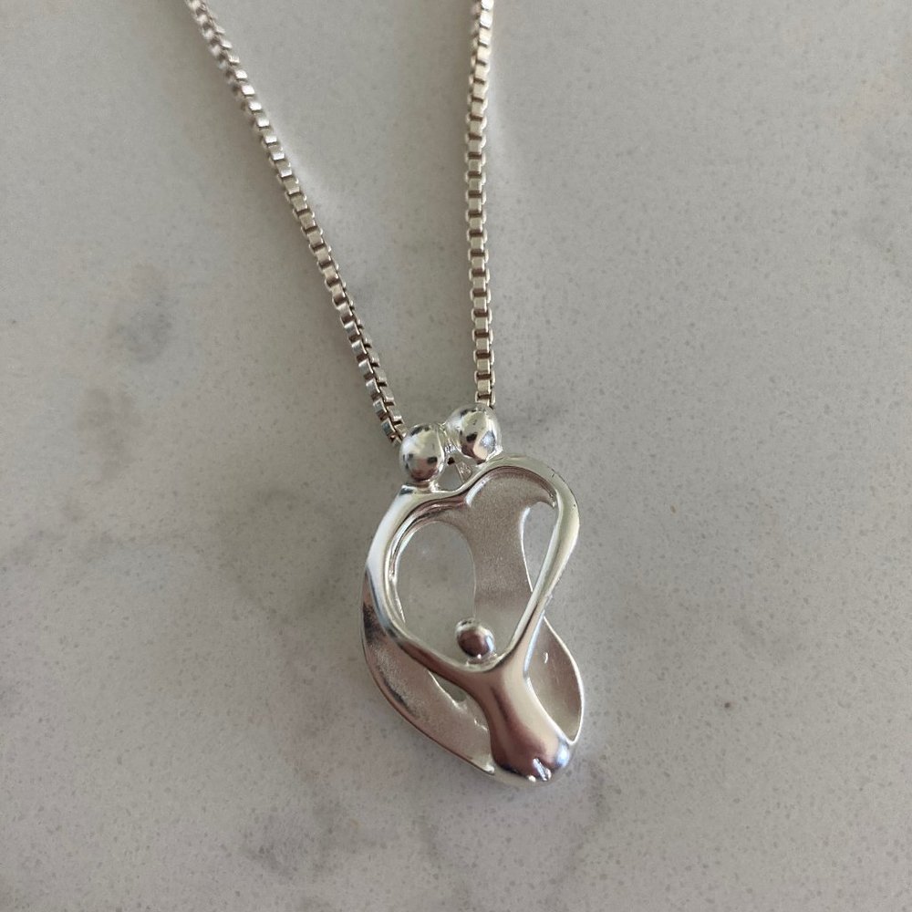 Necklace Featuring Two Parents and Child Pendant